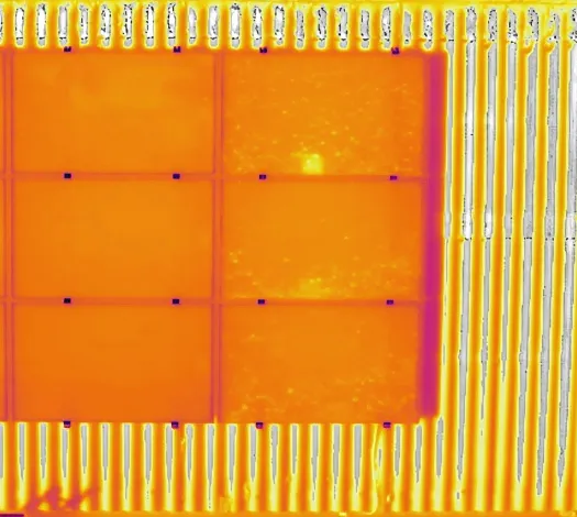 Thermal image of the same PV modules showing a bright cell-level hotspot