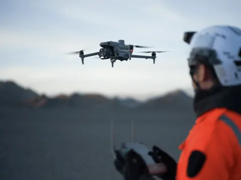 Search and rescue operator launching a DJI drone during a mountain search operation