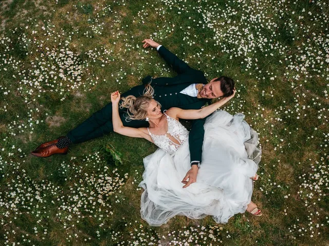 Aerial photograph of a couple lying in a flower field at their wedding — DrohnXit event coverage